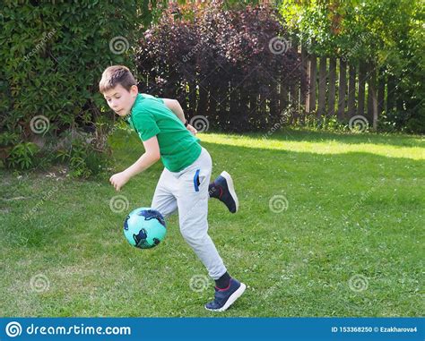 The Boy Runs With A Soccer Ball Stock Photo Image Of Playing