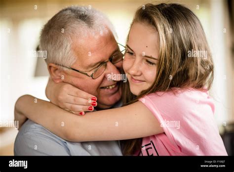 Authentic Photo Of Happy Grandfather Hugging With His Granddaughter