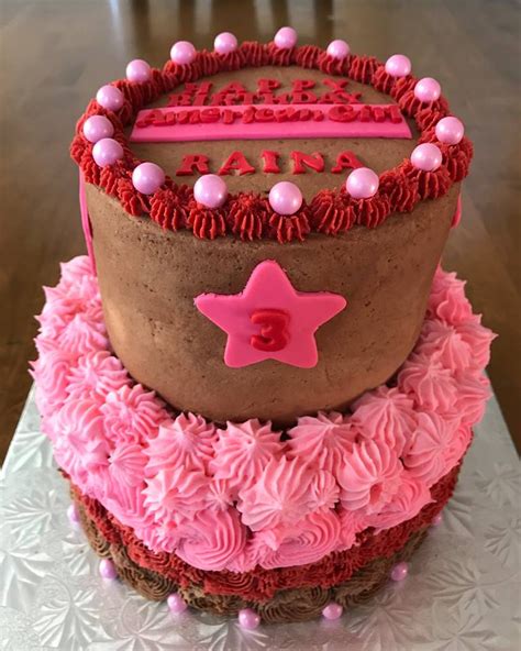 a 2 tier american girl cake the top tier is a 6 inch chocolate cake with a chocolate filling