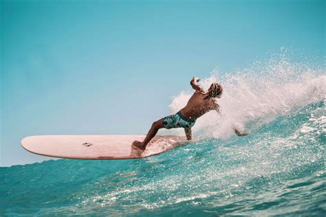 Sporty Shirtless Guy Balancing On Surfboard In Ocean · Free Stock Photo
