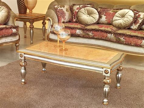 The smaller piles of books are similar in size to balance the entire display. Classic coffee table in carved wood, for Luxury Hotel ...