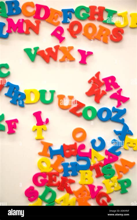 A Jumble Of Colorful Magnetic Alphabet Letters On A White Board In A