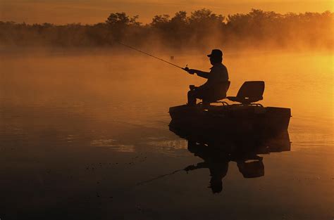 A Man Bass Fishing On The Lake At Dawn Photograph By Arthur Meyerson