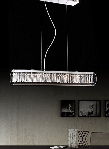 A Rectangular Light Fixture Hanging Over A Dining Room Table