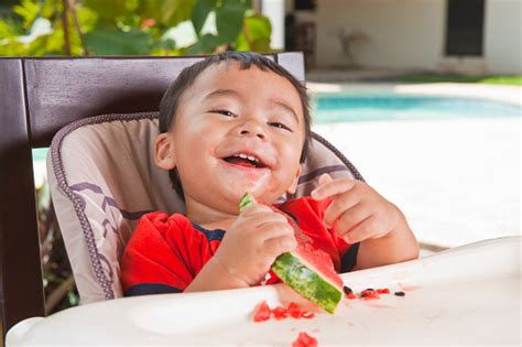 Happy Baby Eating Fruit Stock Photo Download Image Now Baby Human