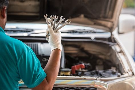 Premium Photo Mechanic Holding Wrenches In Hand Automotive
