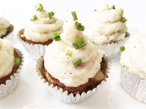 Cupcakes With White Frosting And Green Onions On Top