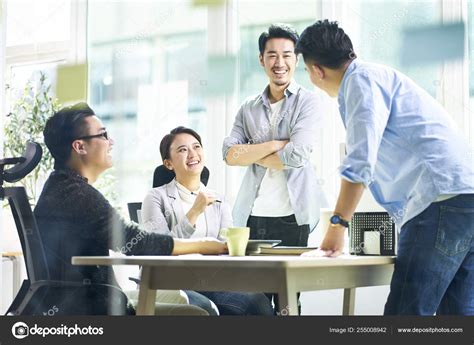 Happy Asian Business Team Meeting In Office Stock Photo By ©imtmphoto