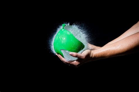 Premium Photo Water Balloon Bursting In Hands