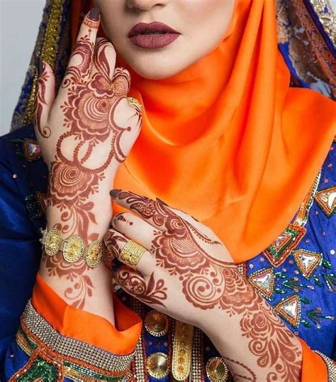 A Woman With Henna On Her Face And Hands