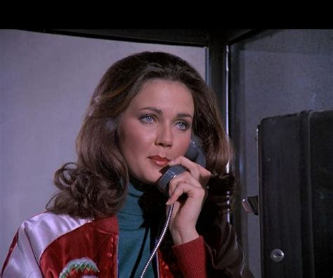 A Woman Talking On A Phone While Wearing A Red And White Jacket