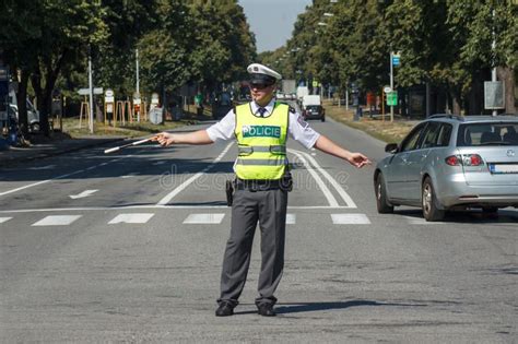 Traffic Police A Policeman Directing Traffic In The Middle Of A