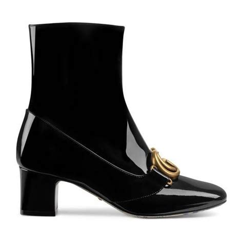 The emblematic double g finishes the front. Gucci Embroidered leather ankle boot with belt | Обувь