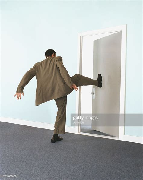 Businessman Kicking Door Rear View High Res Stock Photo Getty Images