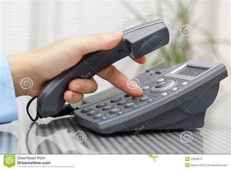 Businessman Hand Is Dialing A Phone Number With Picked Up Headset Stock
