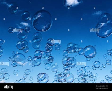 Bubble Floating Against Blue Background Hi Res Stock Photography And
