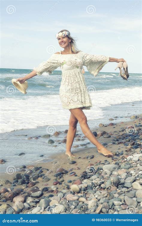 Woman In White Dress Walking Barefoot On The Beach Stock Image Image