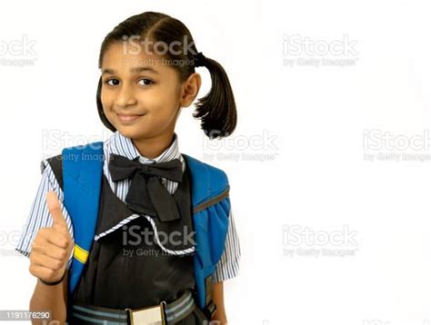 Indian Little School Girl Is Showing Thumb Up Signisolated On White