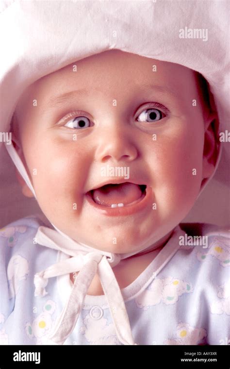 Cute Baby Face With Happy Expression And Big Blue Eyes And Two Front