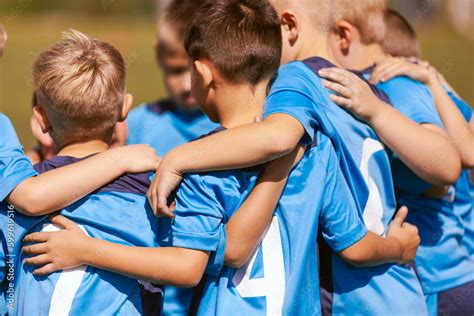 Motivated Kids In Soccer Team Cheering On Court Players Huddling In A