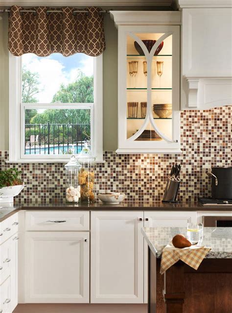 Glass tiles are a wonderful addition to a kitchen design. 18 Gleaming Mosaic Kitchen Backsplash Designs