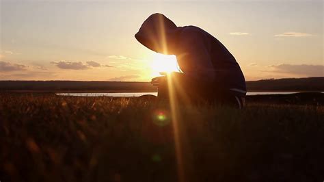 Silhouette Of A Man Praying At Sunset Concept Of Religion Image Of