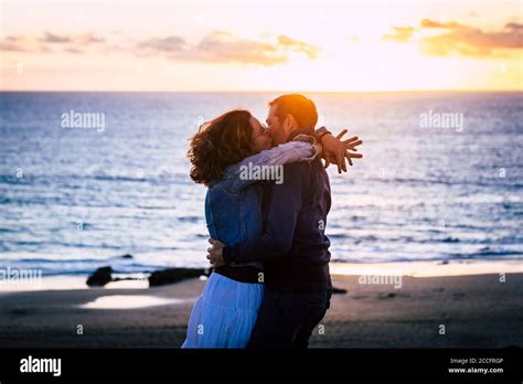 Romantic Couple Enjoying Sunset At The Beach Kissing And Loving Each Other Caucasian People