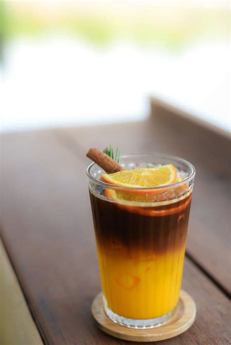 Iced Black Coffee Mixed With Orange Juice In Glass Topping With Sliced