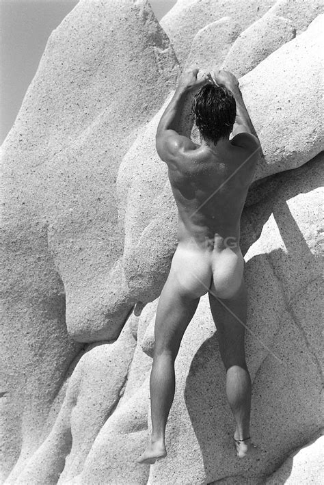 Nude Man Climbing A Rock Formation In Cabo Mexico ROB LANG IMAGES