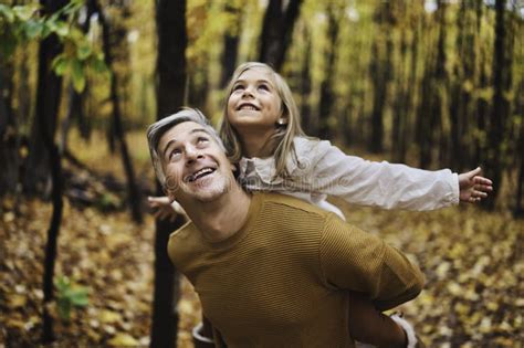 Father And Daughter Having Fun In The Autumn Colorful Forest Stock Image Image Of Cheerful
