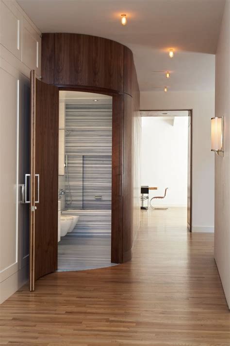 For those who still put a update a white bathroom by taking out the clutter, installing creative storage option and glass shower doors. Rounded bathroom door and wall | Tribeca loft, Modern ...