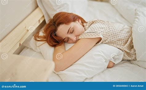 Young Redhead Woman Lying On Bed Hugging Pillow Sleeping At Bedroom