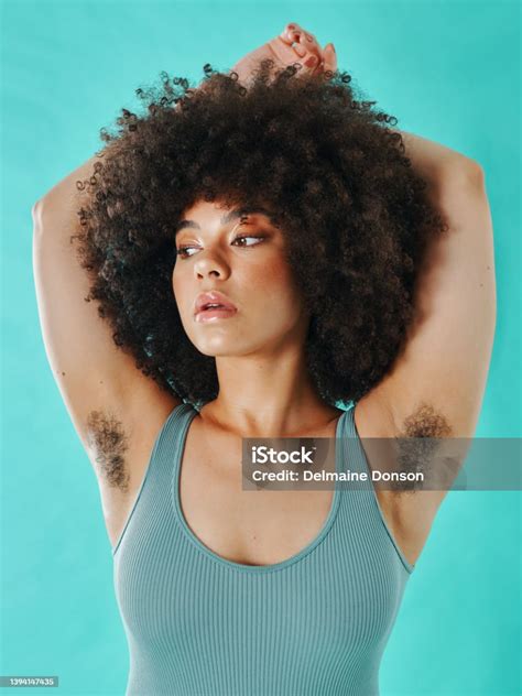 Mixed Race Woman Showing Armpit Hair In The Studio Stock Photo