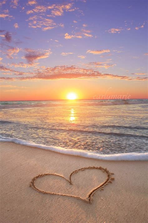A Heart Drawn In The Sand On A Beach At Sunset With An Inspirational