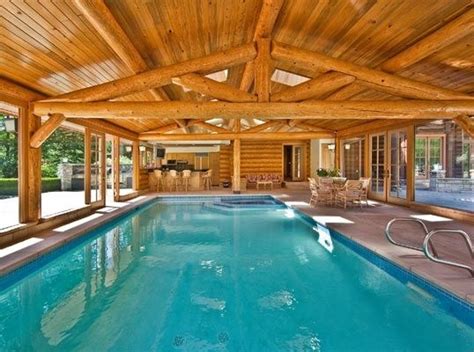 Fireorb next to tub and outdoor kitchen/grill. log home indoor swimming pool | Indoor/Outdoor swimming ...