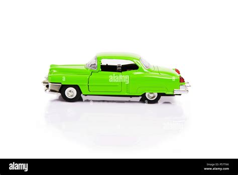 Side View Of Green Model Toy Car In Retro Style On White Background