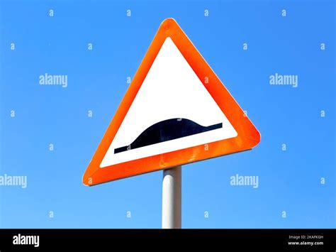Triangle Speed Bump Road Sign Against The Blue Sky Warning Traffic