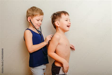 Two Babes Playing Doctor With Stethoscope On White Background Baby Games Stock Photo Adobe Stock
