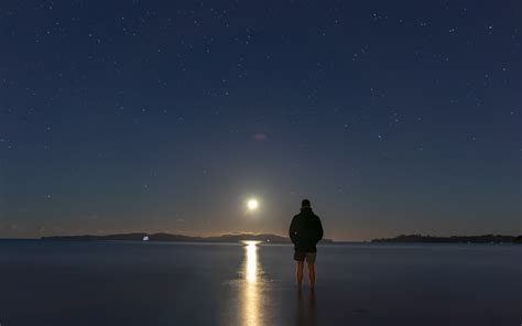 Man Standing On Seashore During Night Time Photo Free Grey Image On
