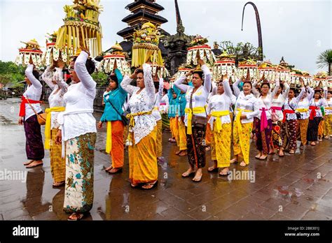 A Group Of Balinese Hindu Women Carrying Temple Offerings At The Batara Turun Kabeh Ceremony