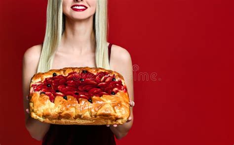 Portrait Of A Young Beautiful Blonde Holding A Delicious Homemade Cherry Pie Stock Image