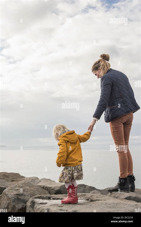Mother And Toddler Walking On Harbor Wall Stock Photo Alamy