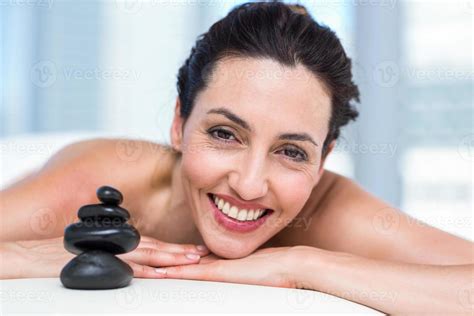 Smiling Brunette Relaxing On Massage Table Stock Photo At Vecteezy