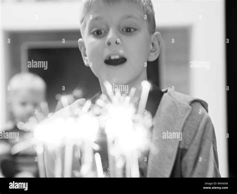 10 Year Old Caucasian Boy Blowing Out Candles On Cake Stock Photo Alamy