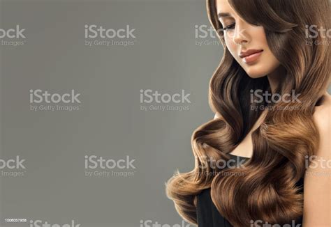 Young Brown Haired Beautiful Model With Long Curly Well Groomed Hair
