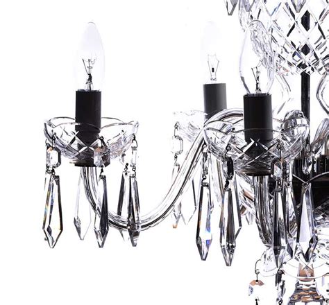 Ten lights with five more interior lights with cut plume top crown underne. WATERFORD CHANDELIER