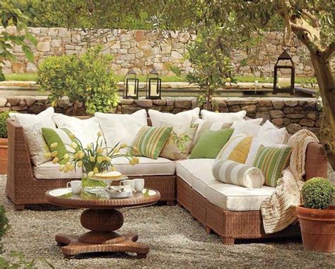 This colorful outdoor sitting space is accented with yellow pillows and a blue mural. Best Colors for Your Patio Furniture | outdoortheme.com