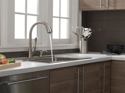 Simply touch anywhere on the spout or handle to start and stop the flow of water. Single Handle Pull-Down Kitchen Faucet with Soap Dispenser ...