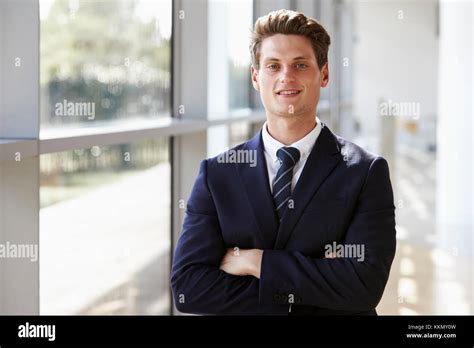 Portrait Of A Young Smiling Professional Man Arms Crossed Stock Photo
