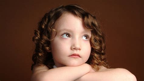 Cute Baby Girl Is Looking Up With Sad Face In Brown Background Hd Cute